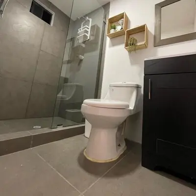 a bathroom with a toilet and a shower at The Cabins in La Libertad