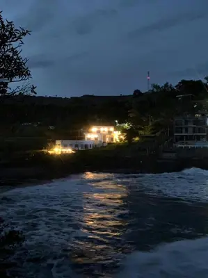a view of a river at night with lights at La Leona 1 in El Zonte