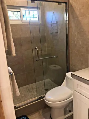 a bathroom with a shower and a toilet at La Leona 1 in El Zonte