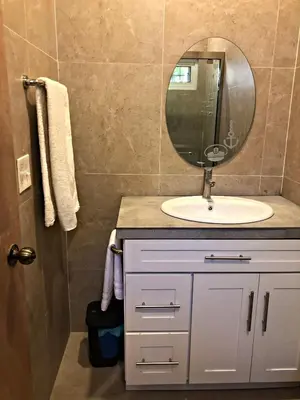 a bathroom with a sink and a mirror at La Leona 1 in El Zonte