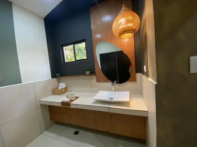 a bathroom with a sink and a mirror at Casa del Golfo El Salvador in Conchagua