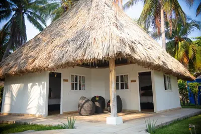 a small house with a straw roof at Casa del Golfo El Salvador in Conchagua