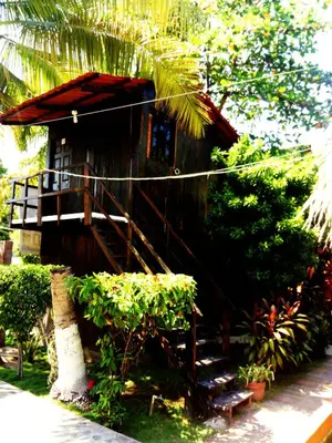 a small house with a staircase leading up to it at Hotel Tunco Lodge in La Libertad