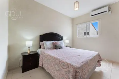 a bedroom with a bed and a window at The Cozy Apartment in San Salvador