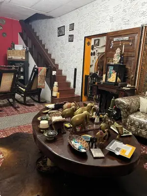 a living room with a table with figurines on it at Mendoza’s GUEST HOUSE in Santa Ana