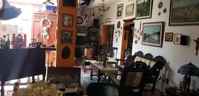a room with chairs and pictures on the wall at Mendoza’s GUEST HOUSE in Santa Ana