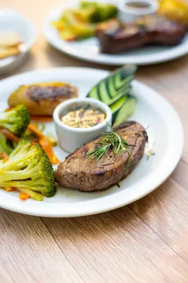 a plate of food with meat and vegetables on a table at amaremar in San Luis