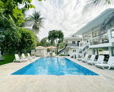 a swimming pool in front of a house with lounge chairs at amaremar in San Luis
