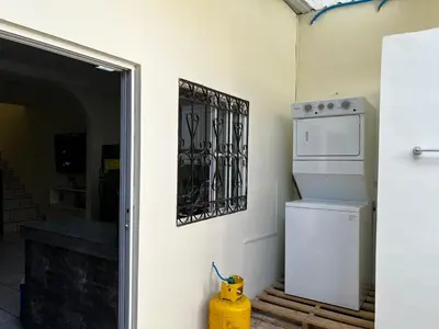 a kitchen with a white refrigerator and a fire hydrant at A 5 minutos de las Ruinas del Tazumal, Chalchuapa Santa Ana El Salvador in Chalchuapa