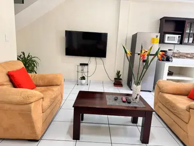 a living room with two couches and a coffee table at A 5 minutos de las Ruinas del Tazumal, Chalchuapa Santa Ana El Salvador in Chalchuapa