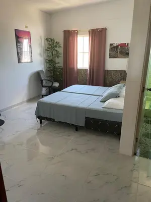 a bedroom with a bed and a chair in it at Playa El Obispo A La Marea building La Libertad in La Libertad