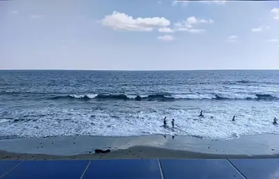 a group of people in the water at the beach at Playa El Obispo B La Marea building La Libertad in La Libertad