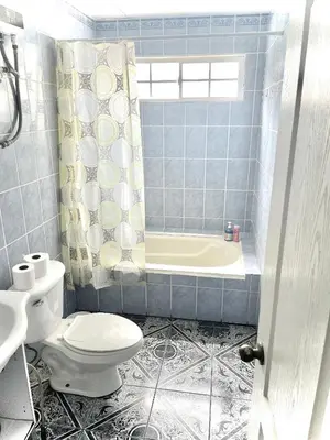 a blue tiled bathroom with a toilet and a tub at Playa El Obispo B La Marea building La Libertad in La Libertad