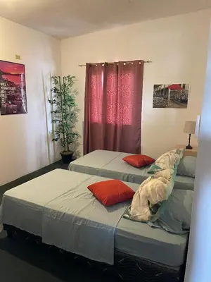 two twin beds in a room with a window at Playa El Obispo B La Marea building La Libertad in La Libertad