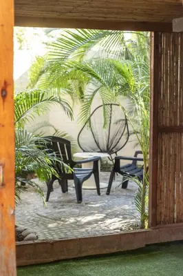 a view of a patio with a table and chairs at La Canasta in El Zonte