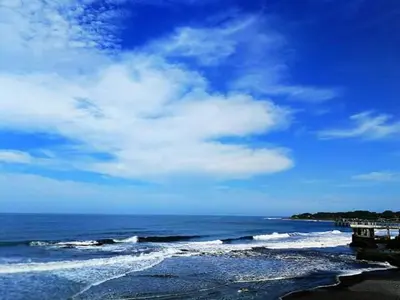 a beach with the ocean and a blue sky and clouds at Playa El Obispo D La Marea building La Libertad in La Libertad