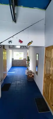 a large room with a blue carpeted floor and a door at Playa El Obispo D La Marea building La Libertad in La Libertad