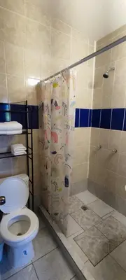 a bathroom with a toilet and a shower at Playa El Obispo D La Marea building La Libertad in La Libertad