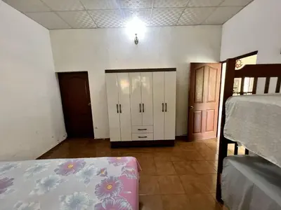 a room with a bedroom with a bed and a closet at Beautiful beach house in Los Cobanos El Salvador in Los Cóbanos