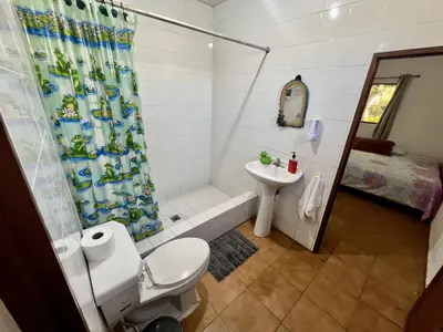 a bathroom with a toilet and a sink and a shower at Beautiful beach house in Los Cobanos El Salvador in Los Cóbanos