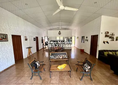 a living room with a couch and a table and chairs at Beautiful beach house in Los Cobanos El Salvador in Los Cóbanos
