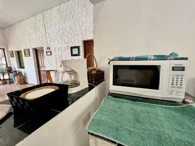 a microwave sitting on a counter in a kitchen at Beautiful beach house in Los Cobanos El Salvador in Los Cóbanos