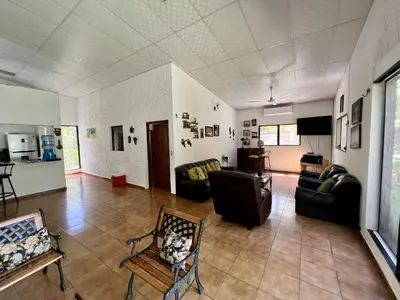 a living room with couches and a tv in it at Beautiful beach house in Los Cobanos El Salvador in Los Cóbanos