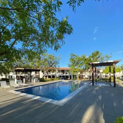 a swimming pool with chairs and a pavilion at Casa llena de naturaleza y paz perfecta para descansar. in San Miguel