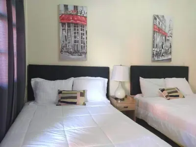 two beds sitting next to each other in a bedroom at Sambo Mambo Beach Hotel in El Cuco