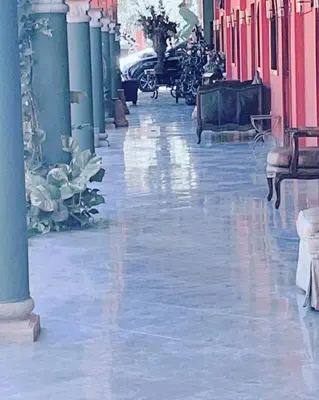 an empty hallway of a building with pink and blue columns at Sambo Mambo Beach Hotel in El Cuco