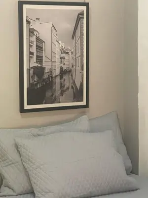 a black and white picture hanging above a bed at Sambo Mambo Beach Hotel in El Cuco