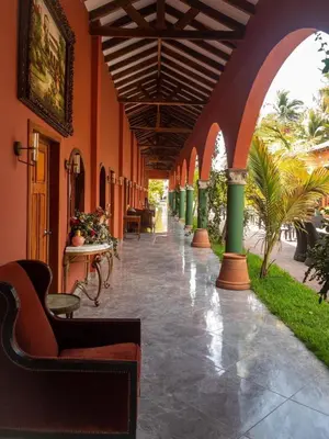 a hallway with chairs and tables in a building at Sambo Mambo Beach Hotel in El Cuco
