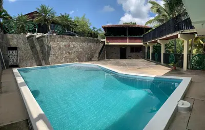 a large swimming pool in front of a house at Green Canyon in El Jurón