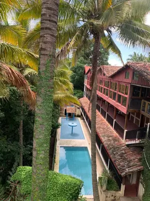 an aerial view of a resort with a swimming pool and palm trees at Green Canyon in El Jurón