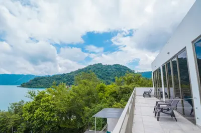 a balcony with a view of the water and mountains at Equinoccio Hotel in Santa Ana