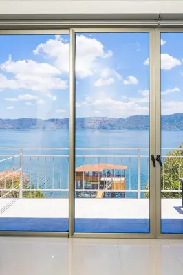a room with a view of the water seen through a window at Equinoccio Hotel in Santa Ana