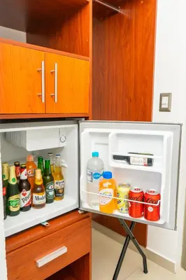 an open refrigerator filled with lots of drinks at Equinoccio Hotel in Santa Ana