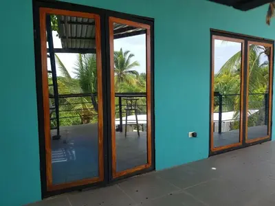 an open door to a house with a patio at Lote 44 Guesthouse in El Zonte