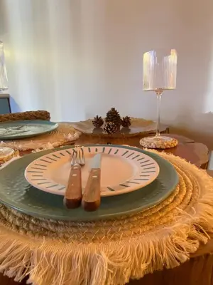 a table with a plate and two utensils on it at Orquídea Loft in Juayúa