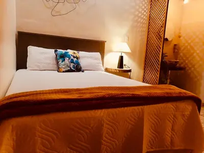 a bedroom with a large bed with a pillow on it at Orquídea Loft in Juayúa
