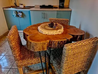 a wooden table with chairs and a bowl of food on it at Orquídea Loft in Juayúa