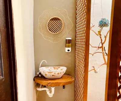 a bathroom with a bowl on a wooden shelf at Cafeto Loft Lovely and private loft in Ruta de las Flores heart in Juayúa