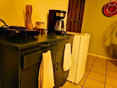 a kitchen with a stove with towels on it at Cafeto Loft Lovely and private loft in Ruta de las Flores heart in Juayúa
