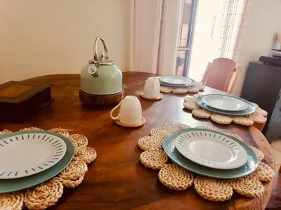 a wooden table with plates and a teapot on it at Cafeto Loft Lovely and private loft in Ruta de las Flores heart in Juayúa