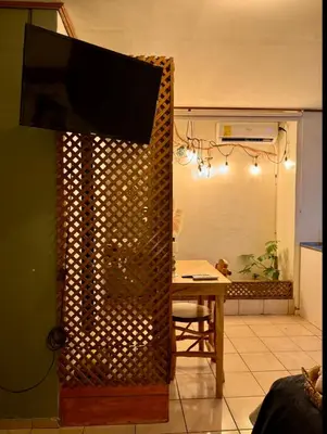 a living room with a television on top of a wall at Cafeto Loft Lovely and private loft in Ruta de las Flores heart in Juayúa