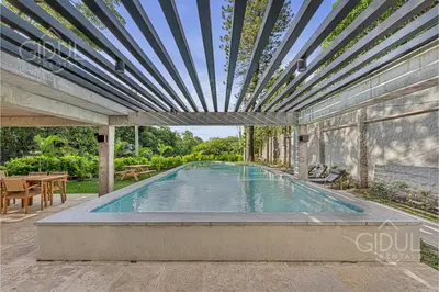 a swimming pool in a house with a pergola at Cozy, Modern and Centric Apartment with pool and gym in San Salvador