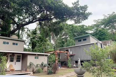 a house and a building with a tree at Wabi Sabi , casa de playa in Tamanique