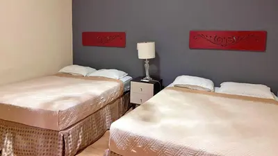 two beds sitting next to each other in a room at Quinta Sunset, Lago de Coatepeque in El Congo