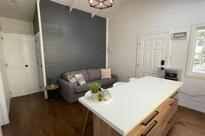 a living room with a couch and a table at Treehouse in Tamanique