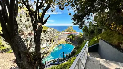 an aerial view of a house with a swimming pool at Treehouse in Tamanique